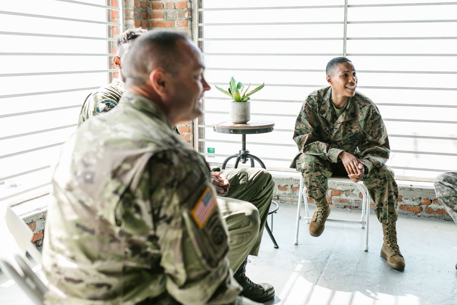 A group of people in military uniform talking together